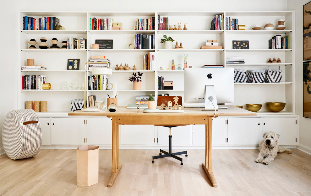 Inspiration for a mid-sized scandinavian freestanding desk light wood floor study room remodel in Gothenburg with white walls and no fireplace