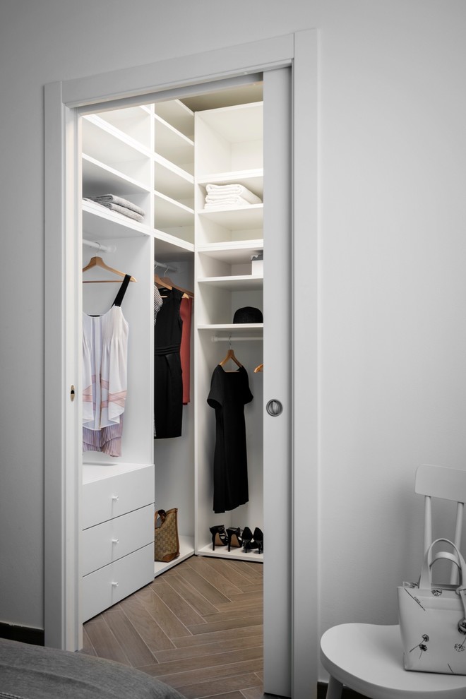 Aménagement d'un petit dressing contemporain neutre avec un placard sans porte, des portes de placard blanches, un sol en carrelage de porcelaine et un sol gris.