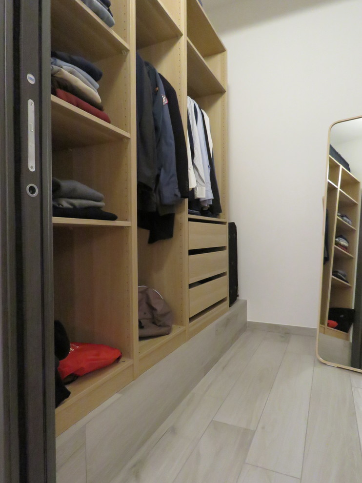 Photo of a small modern walk-in wardrobe for men in Catania-Palermo with open cabinets, light wood cabinets, porcelain flooring and beige floors.