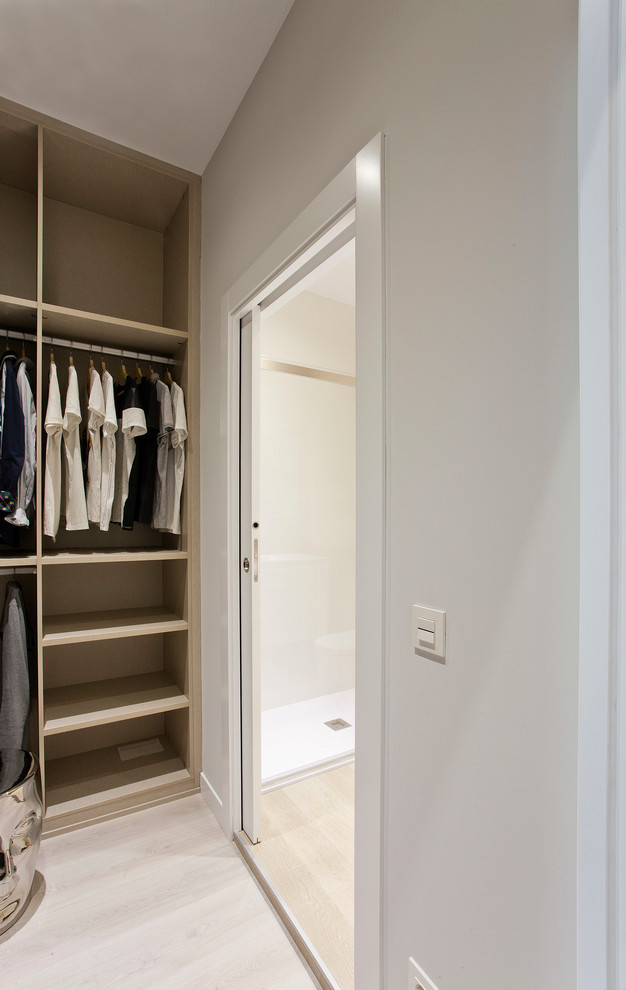 Photo of a medium sized contemporary gender neutral walk-in wardrobe in Other with open cabinets.