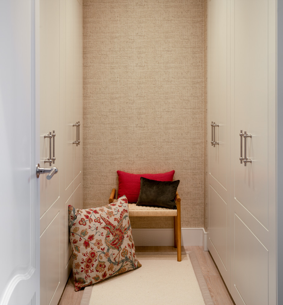 Small classic gender neutral walk-in wardrobe in Bilbao with raised-panel cabinets, white cabinets, laminate floors, beige floors and a drop ceiling.