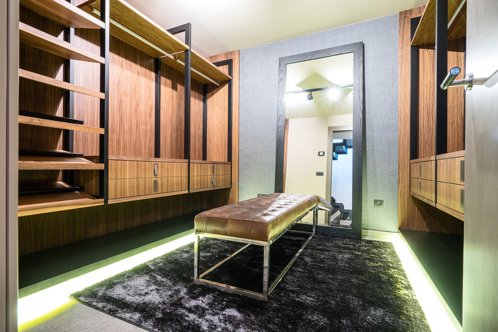 Idee per una grande cabina armadio per uomo moderna con nessun'anta, ante in legno scuro, pavimento in gres porcellanato e pavimento grigio