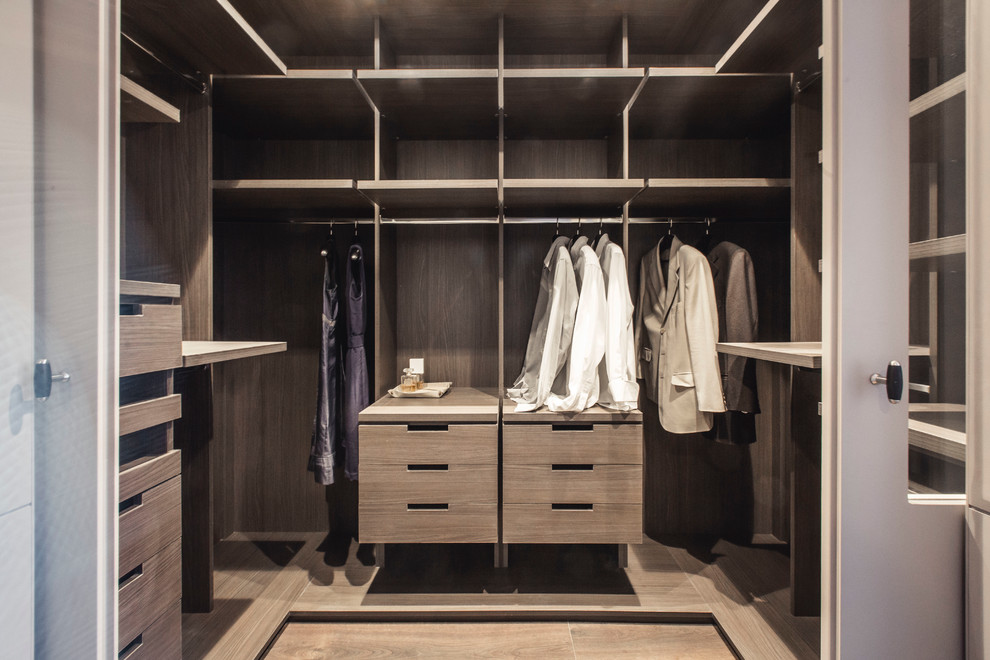 Design ideas for a medium sized traditional gender neutral standard wardrobe in Barcelona with open cabinets and medium wood cabinets.