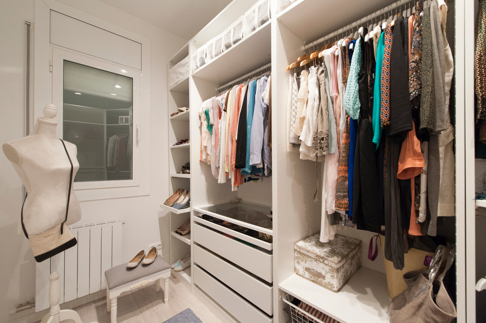 Modelo de armario vestidor de mujer escandinavo de tamaño medio con armarios abiertos, puertas de armario blancas y suelo de madera clara