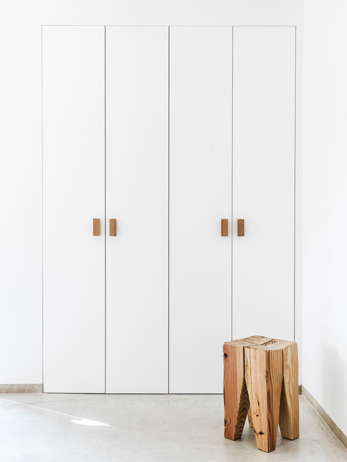 Imagen de armario unisex nórdico pequeño con armarios con paneles lisos y puertas de armario blancas
