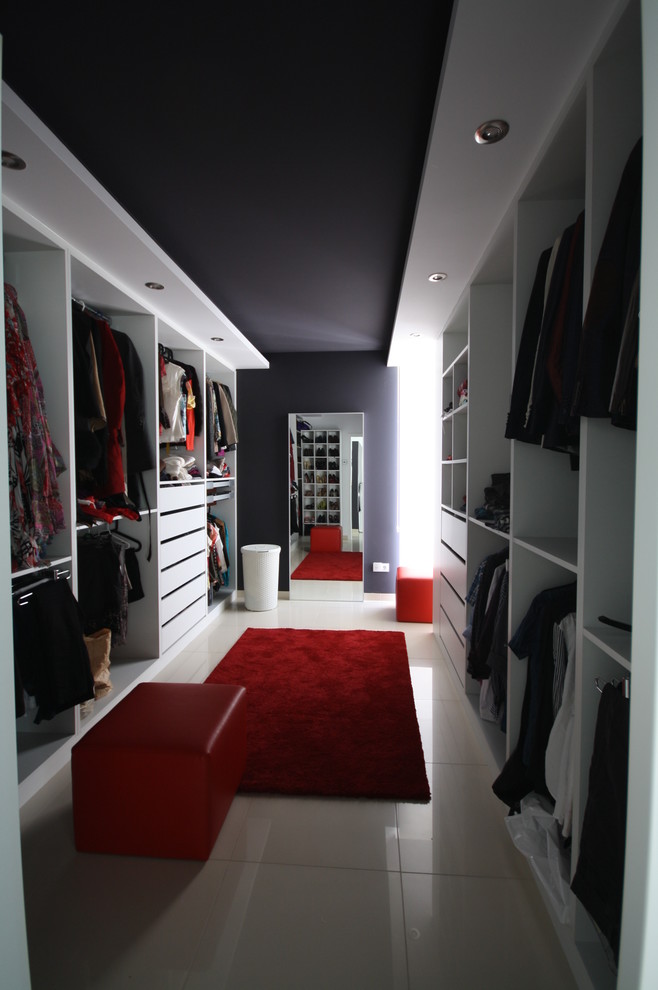 Large trendy women's dressing room photo in Other with open cabinets and white cabinets