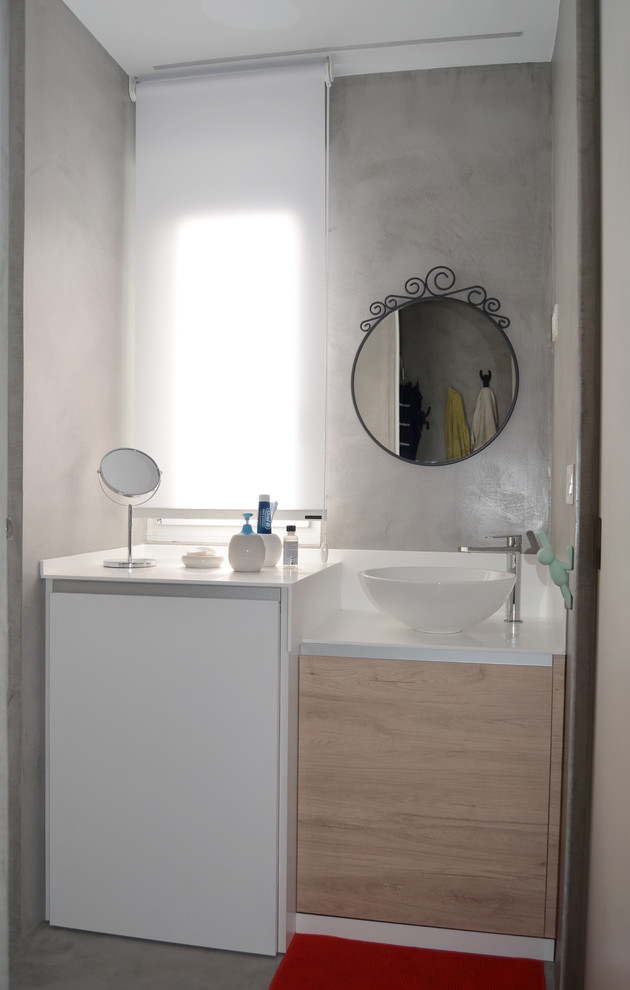 Design ideas for a small modern cloakroom in Bilbao with flat-panel cabinets, grey cabinets and solid surface worktops.