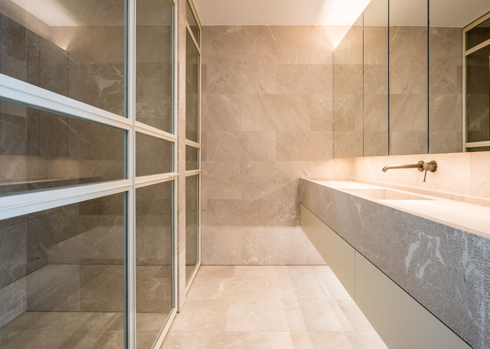 This is an example of a mediterranean cloakroom in Palma de Mallorca with flat-panel cabinets, grey tiles, stone tiles and grey floors.