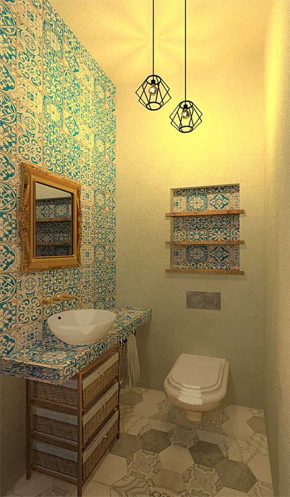 Design ideas for a small urban cloakroom in Other with open cabinets, white cabinets, a wall mounted toilet, blue tiles, ceramic tiles, beige walls, cement flooring, a vessel sink, tiled worktops, grey floors and blue worktops.