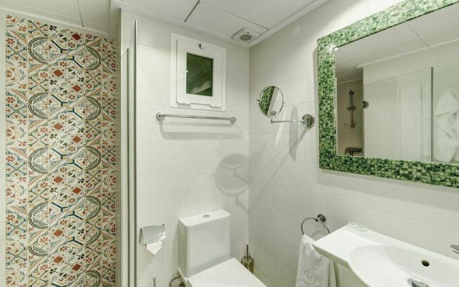 Imagen de aseo mediterráneo pequeño con sanitario de dos piezas y lavabo suspendido