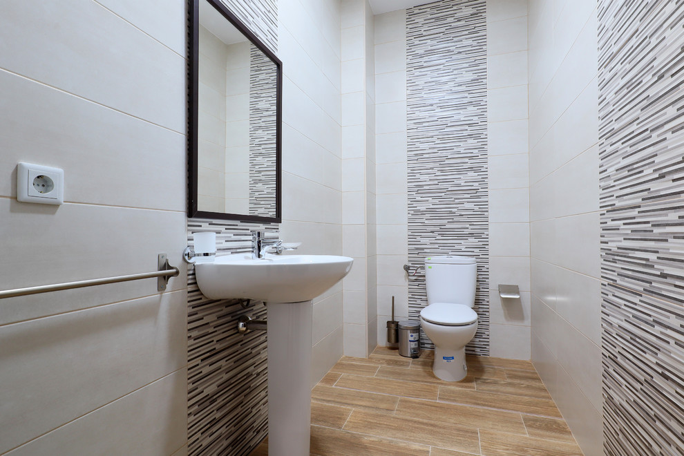 Inspiration for a small modern cloakroom in Other with an urinal, beige tiles, ceramic tiles, white walls, ceramic flooring, a trough sink and beige floors.