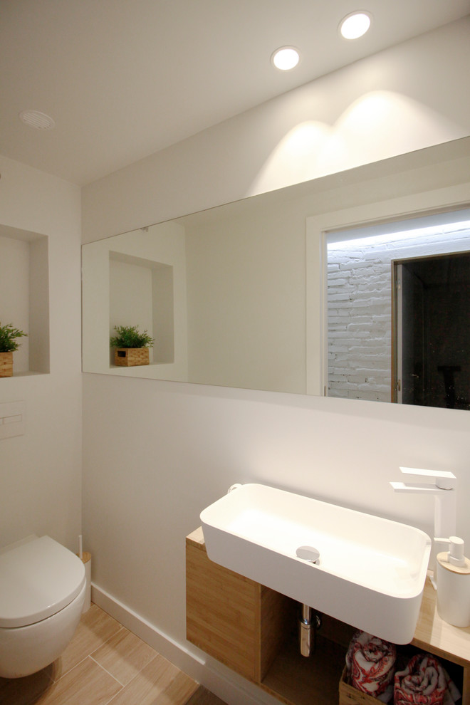 Photo of a small scandi cloakroom in Other with open cabinets, medium wood cabinets, white walls, ceramic flooring, a vessel sink and wooden worktops.