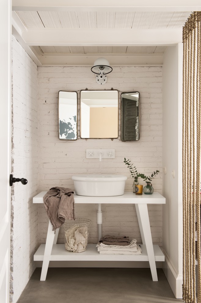 Small shabby-chic style cloakroom in Other with open cabinets, white cabinets, a vessel sink, white walls, concrete flooring and grey floors.