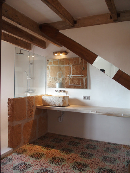 Inspiration for a medium sized rustic cloakroom in Palma de Mallorca with open cabinets, white walls and a vessel sink.
