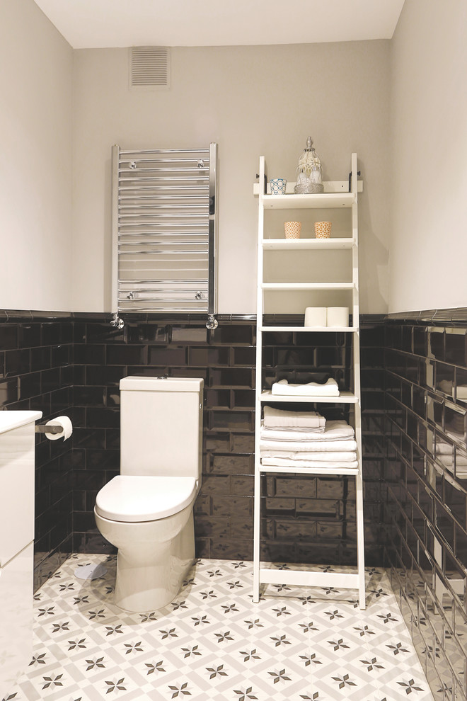 Inspiration for a medium sized urban cloakroom in Madrid with flat-panel cabinets, white cabinets, a two-piece toilet, white walls, ceramic flooring and an integrated sink.