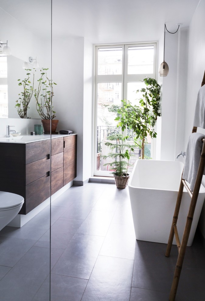 Design ideas for a medium sized scandinavian bathroom in Odense with flat-panel cabinets and dark wood cabinets.