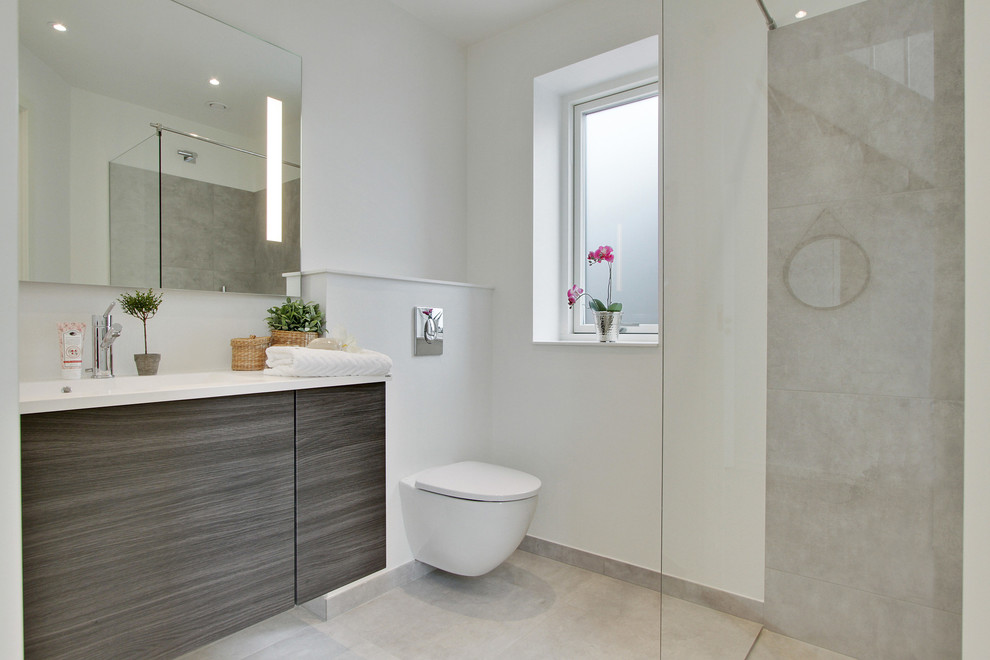 Photo of a medium sized modern bathroom in Copenhagen with flat-panel cabinets, dark wood cabinets, white walls and beige floors.