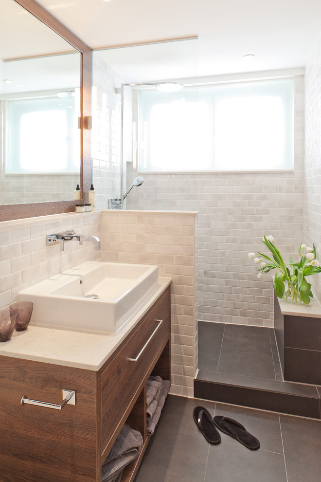 This is an example of a small contemporary shower room bathroom in Berlin with an alcove shower, white tiles, metro tiles, slate flooring, a vessel sink, flat-panel cabinets and medium wood cabinets.