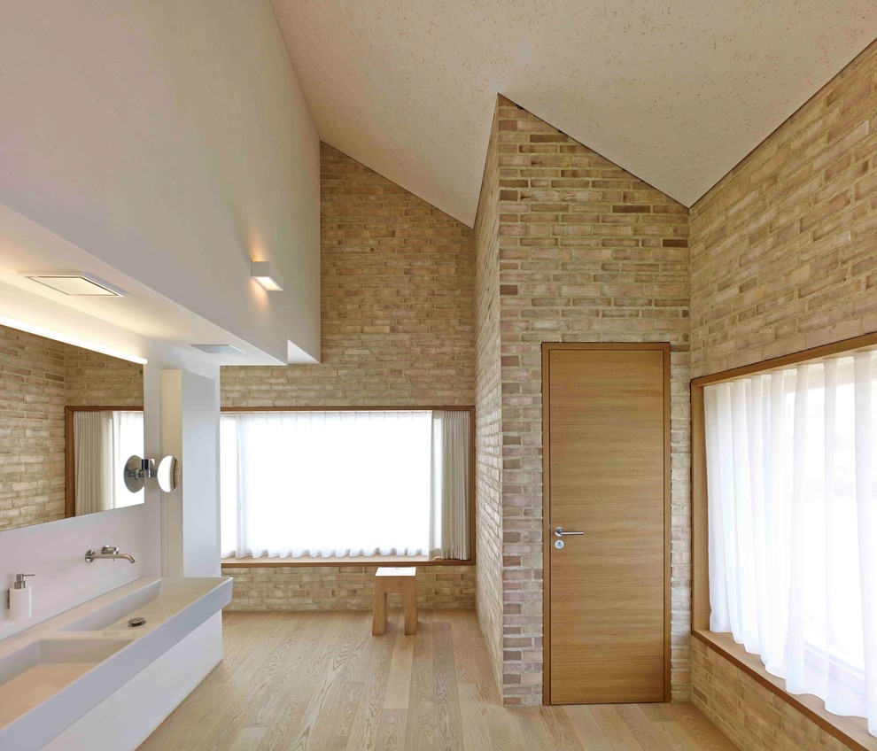 Großes Modernes Badezimmer mit bunten Wänden, braunem Holzboden, Wandwaschbecken und braunem Boden in Stuttgart