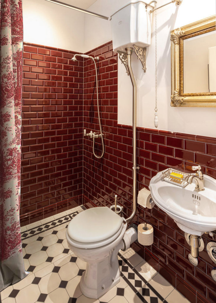 Classic bathroom in Other with a one-piece toilet, red tiles, a wall-mounted sink, white floors, a single sink and a floating vanity unit.