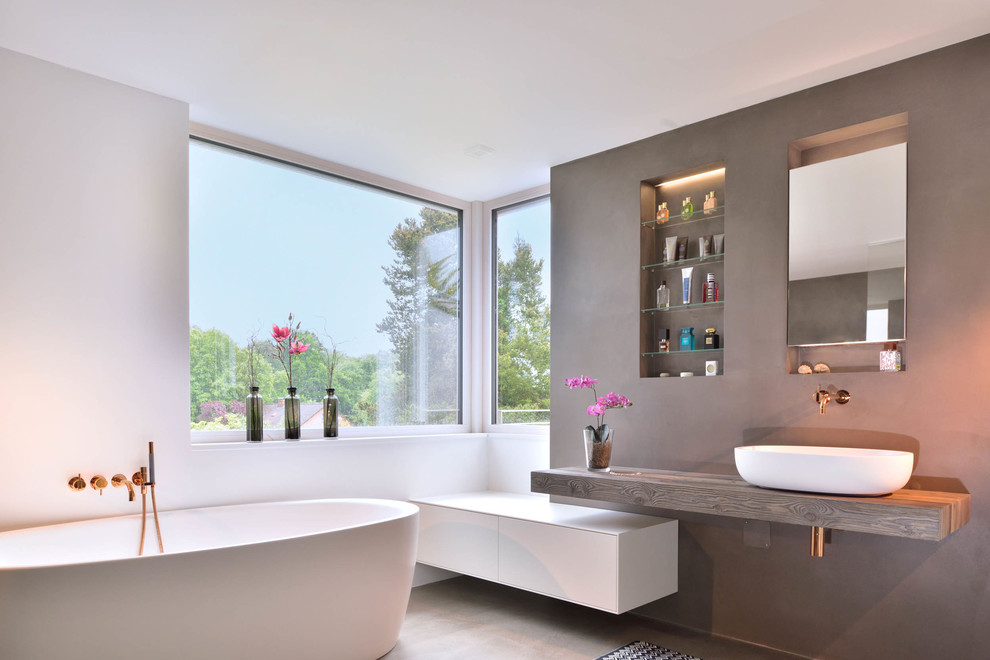 Design ideas for a medium sized modern bathroom in Other with flat-panel cabinets, white cabinets, a freestanding bath, white walls, a vessel sink, wooden worktops, beige floors and brown worktops.