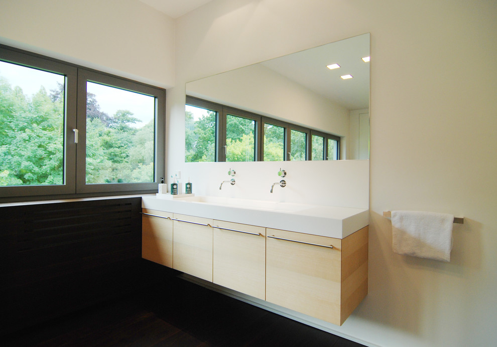 Medium sized contemporary bathroom in Other with flat-panel cabinets, light wood cabinets, white walls and a vessel sink.