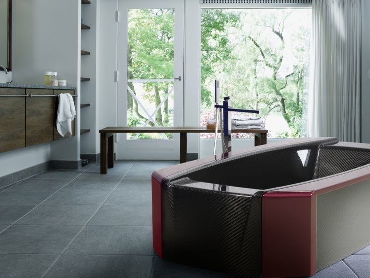 This is an example of a large modern ensuite bathroom in Stuttgart with a freestanding bath and ceramic flooring.