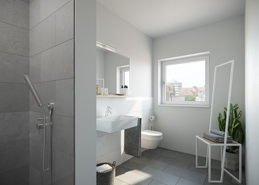 Foto di una piccola stanza da bagno con doccia minimalista con porta doccia a battente, piastrelle grigie, pareti bianche e pavimento grigio