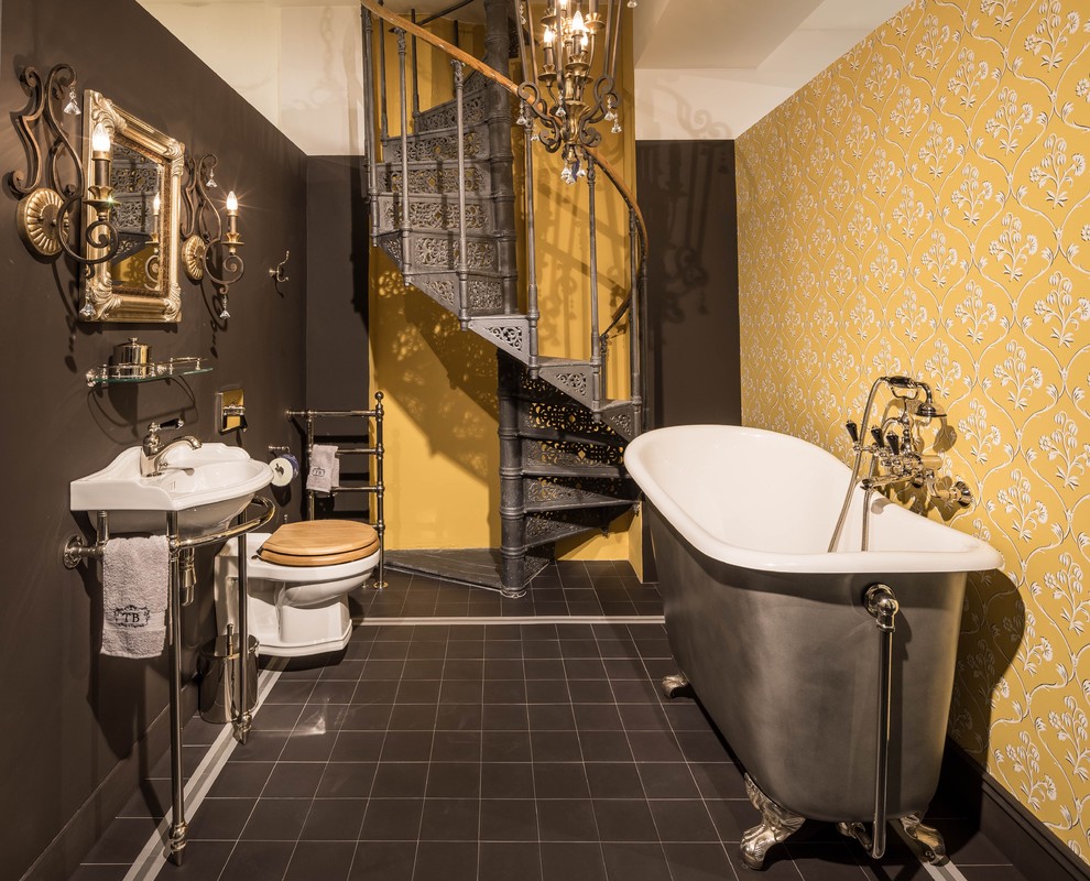 Foto de cuarto de baño tradicional de tamaño medio con bañera exenta, sanitario de dos piezas, paredes amarillas, suelo de baldosas de cerámica y suelo marrón