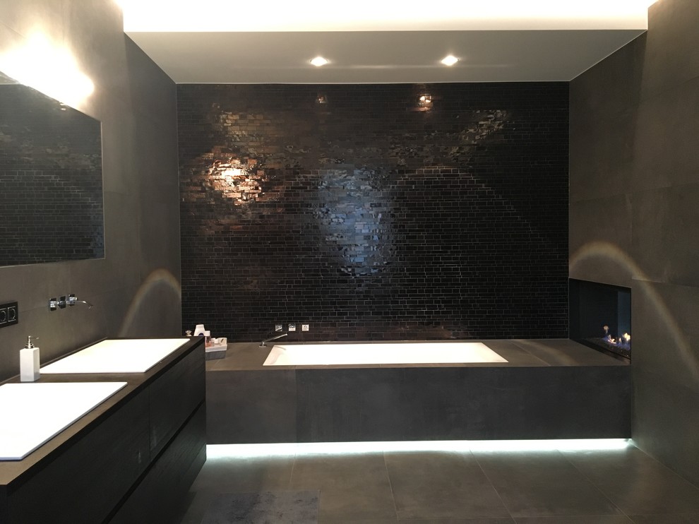 Bathroom - large contemporary 3/4 matchstick tile cement tile floor and brown floor bathroom idea in Dusseldorf with flat-panel cabinets, black cabinets, brown walls, a drop-in sink and solid surface countertops
