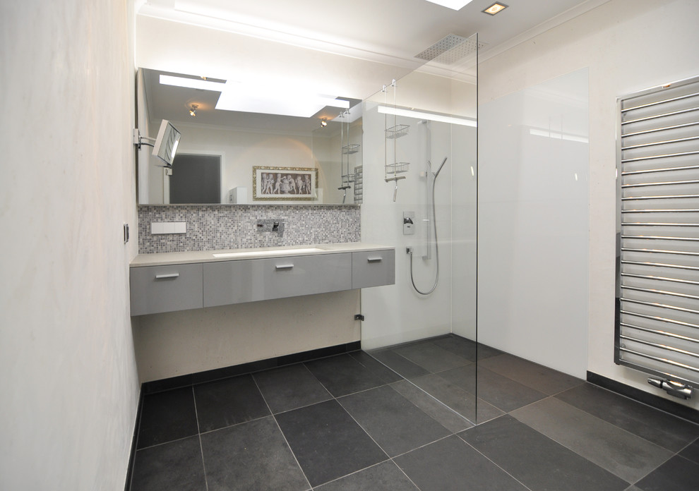Inspiration for a medium sized traditional bathroom in Hanover with flat-panel cabinets, grey cabinets, a walk-in shower, grey tiles, mosaic tiles, white walls, slate flooring, a submerged sink, solid surface worktops and an open shower.
