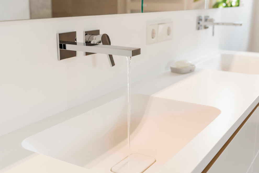 Bathroom - mid-sized contemporary master double-sink bathroom idea in Munich with white cabinets, a drop-in sink, solid surface countertops, white countertops and a built-in vanity