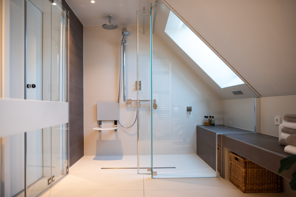 Contemporary bathroom in Other with a two-piece toilet, beige tiles, grey walls, a console sink, wooden worktops, beige floors, a hinged door and white worktops.