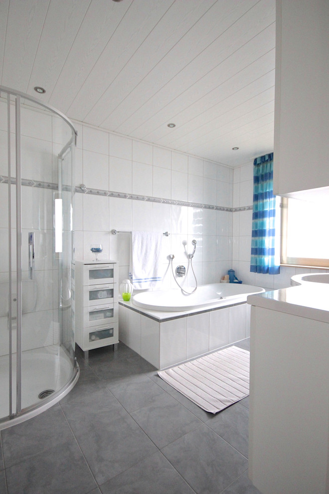 Photo of a medium sized contemporary shower room bathroom in Frankfurt with white cabinets, a built-in bath, a corner shower, white tiles, porcelain tiles, an integrated sink, grey floors, a sliding door and white worktops.