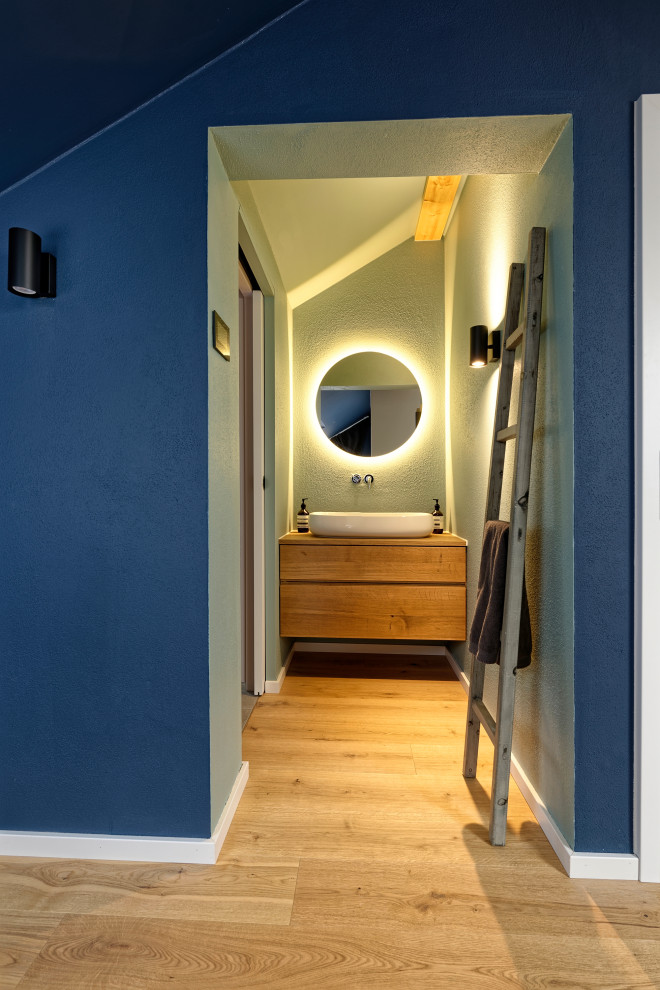 Photo of a medium sized contemporary shower room bathroom in Munich with flat-panel cabinets, brown cabinets, green walls, light hardwood flooring, a vessel sink, wooden worktops, beige floors and brown worktops.