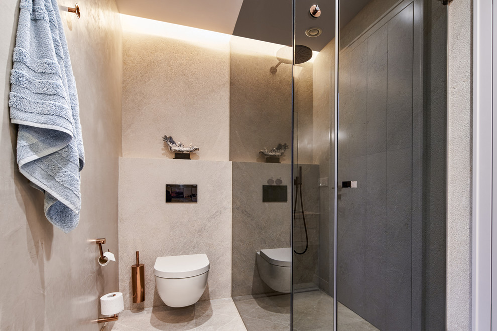 Mittelgroßes Mediterranes Duschbad mit bodengleicher Dusche, Wandtoilette mit Spülkasten, beiger Wandfarbe, beigem Boden und Falttür-Duschabtrennung in Palma de Mallorca
