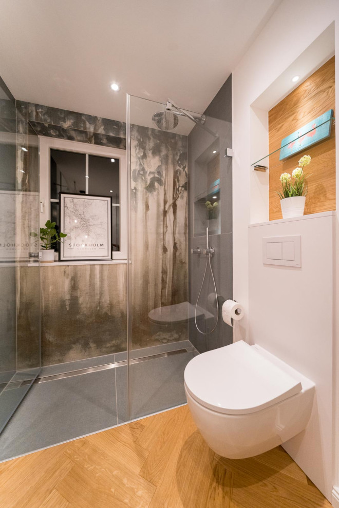 Design ideas for a medium sized contemporary shower room bathroom in Hamburg with flat-panel cabinets, white cabinets, a built-in shower, a two-piece toilet, green tiles, ceramic tiles, white walls, medium hardwood flooring, a vessel sink, engineered stone worktops, an open shower and white worktops.