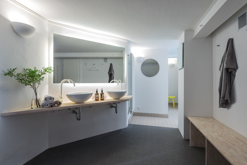 Großes Modernes Badezimmer mit beigen Fliesen, weißer Wandfarbe, Aufsatzwaschbecken, Waschtisch aus Holz, Keramikfliesen und Pflanzen in Berlin
