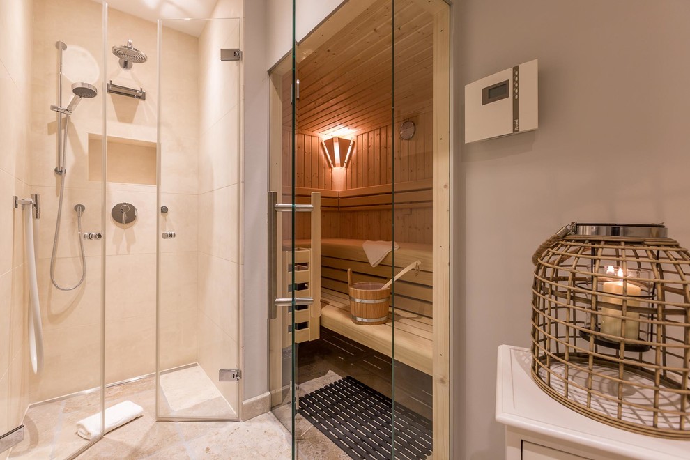 This is an example of a small beach style sauna bathroom in Other with a built-in shower, beige tiles, cement tiles, beige walls, cement flooring, beige floors and a hinged door.