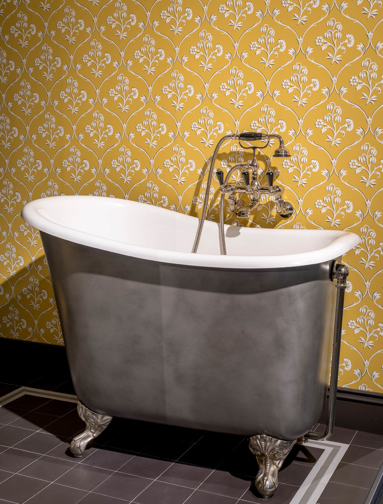 This is an example of a medium sized classic bathroom in Munich with a two-piece toilet, yellow walls, ceramic flooring, a console sink and black floors.