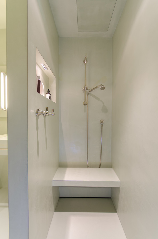 This is an example of a medium sized contemporary bathroom in Munich with raised-panel cabinets, green cabinets, a submerged bath, a built-in shower, a bidet, green walls, a submerged sink, green floors and an open shower.