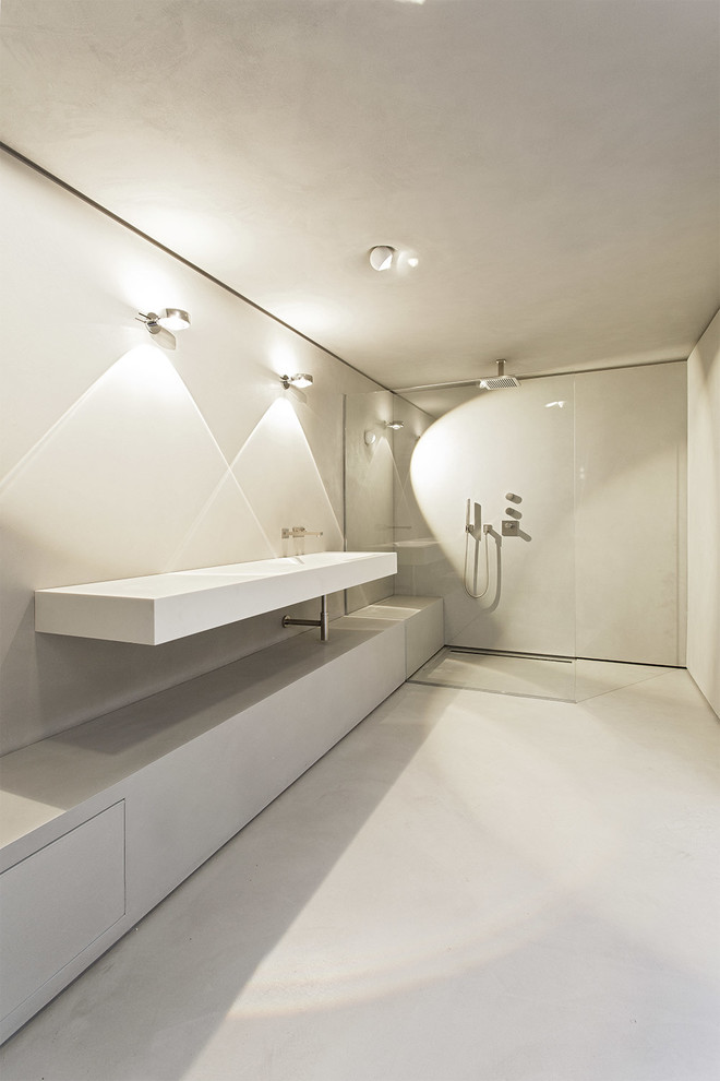 Modern inredning av ett stort badrum, med grå väggar och ett väggmonterat handfat