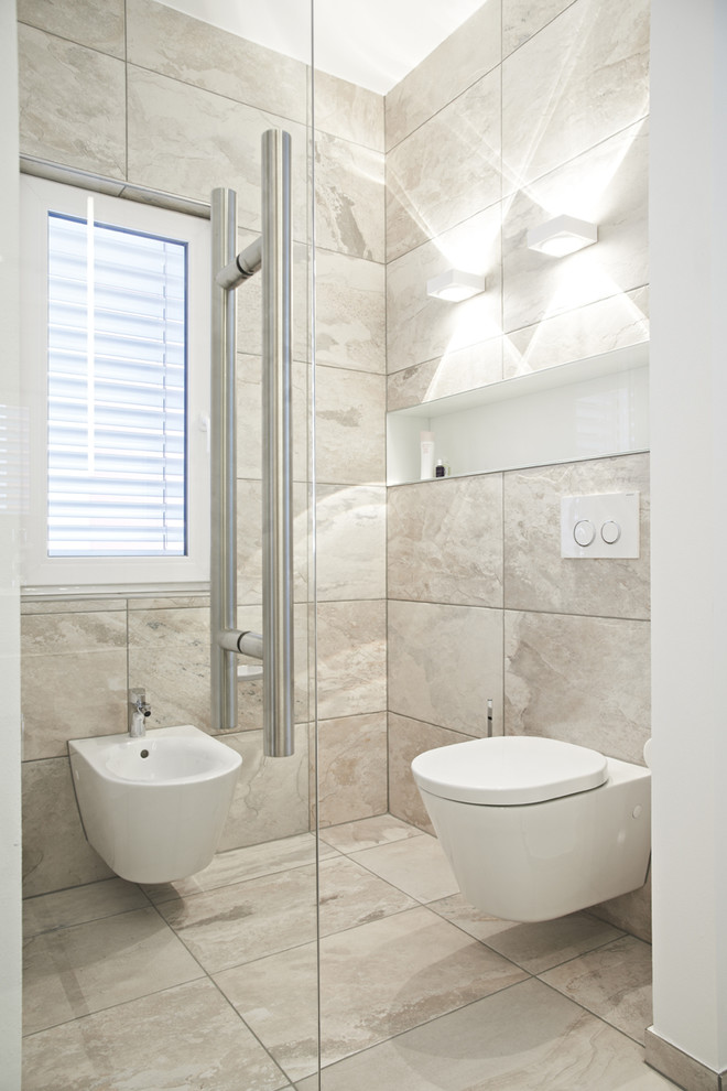 Ejemplo de cuarto de baño actual con baldosas y/o azulejos grises, bidé y baldosas y/o azulejos de piedra