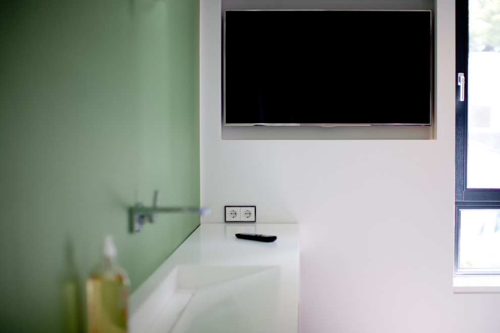 Diseño de cuarto de baño minimalista con puertas de armario marrones, bañera encastrada, paredes blancas y lavabo sobreencimera