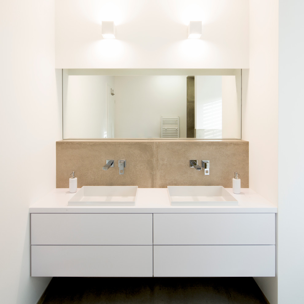 Modelo de cuarto de baño actual con baldosas y/o azulejos marrones, losas de piedra y lavabo encastrado