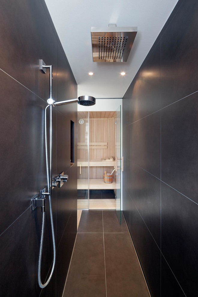 Design ideas for a contemporary sauna bathroom in Cologne with black tiles.