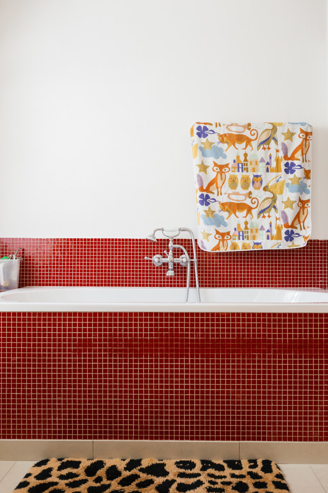 Cette image montre une salle de bain bohème avec une baignoire posée, un combiné douche/baignoire, un carrelage rouge, mosaïque et un mur blanc.