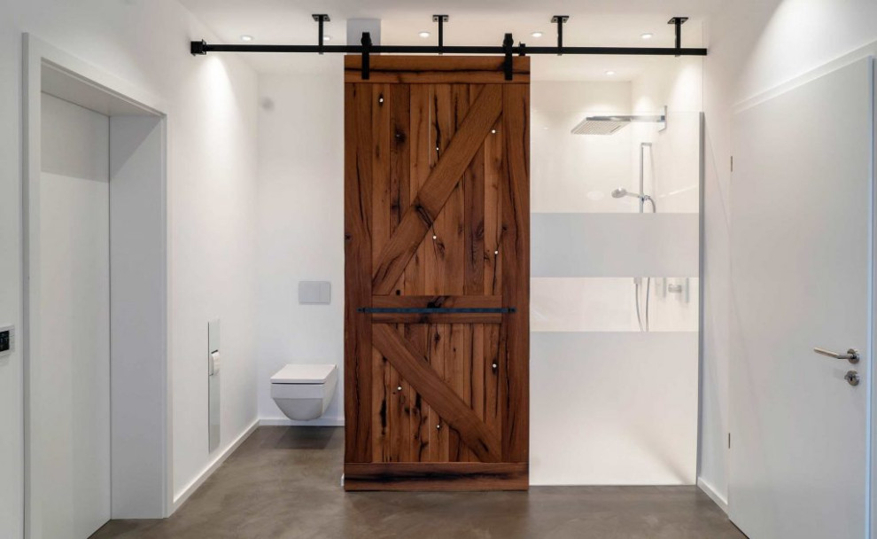 Exempel på ett stort modernt brun brunt en-suite badrum, med luckor med profilerade fronter, vita skåp, ett fristående badkar, en vägghängd toalettstol, brun kakel, marmorkakel, vita väggar, ett fristående handfat, marmorbänkskiva och brunt golv