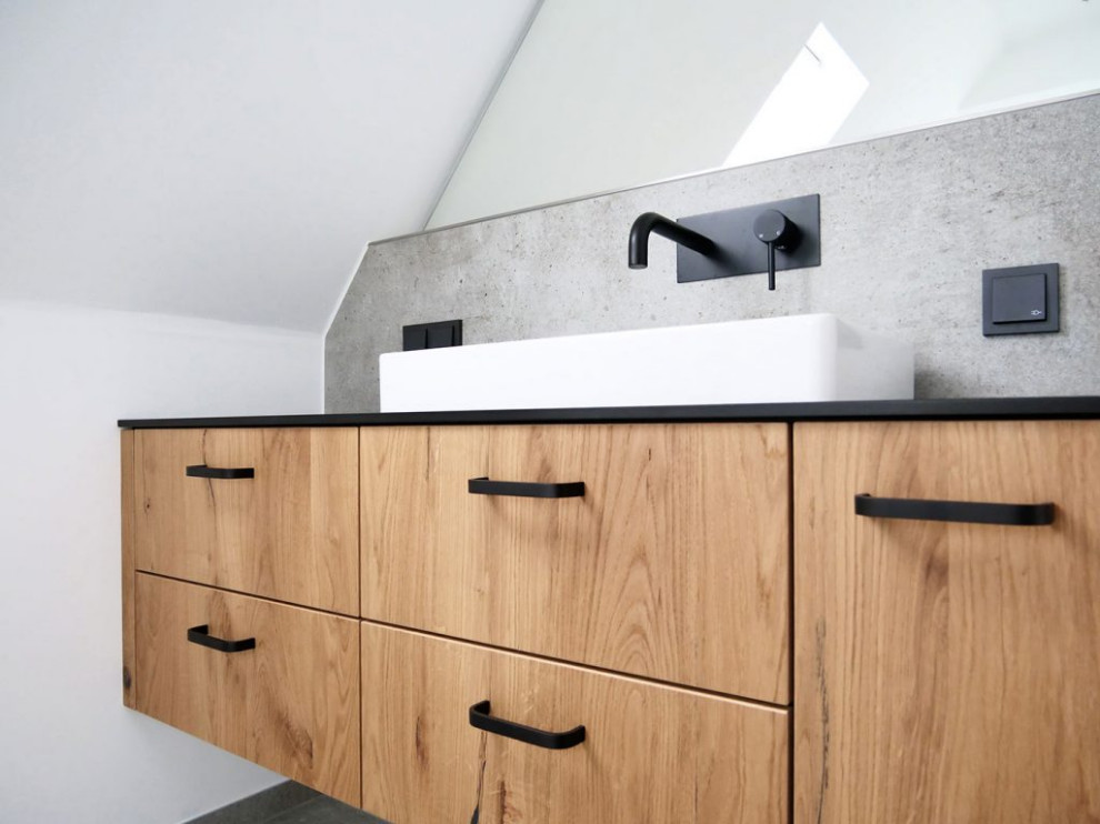 Medium sized contemporary ensuite bathroom in Other with beaded cabinets, brown cabinets, a built-in shower, a wall mounted toilet, grey tiles, grey walls, a vessel sink, wooden worktops, black floors, an open shower, brown worktops, a single sink and a floating vanity unit.