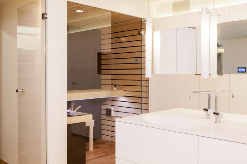 Modernes Badezimmer mit weißen Schränken, weißer Wandfarbe und Betonboden in Stuttgart